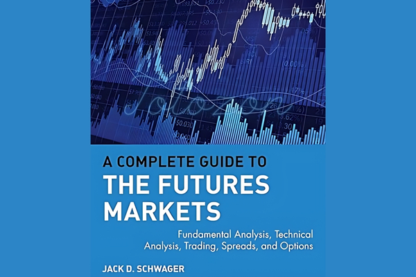 Jack Schwager’s book on a desk, surrounded by charts and financial documents, symbolizing deep insights into futures trading.